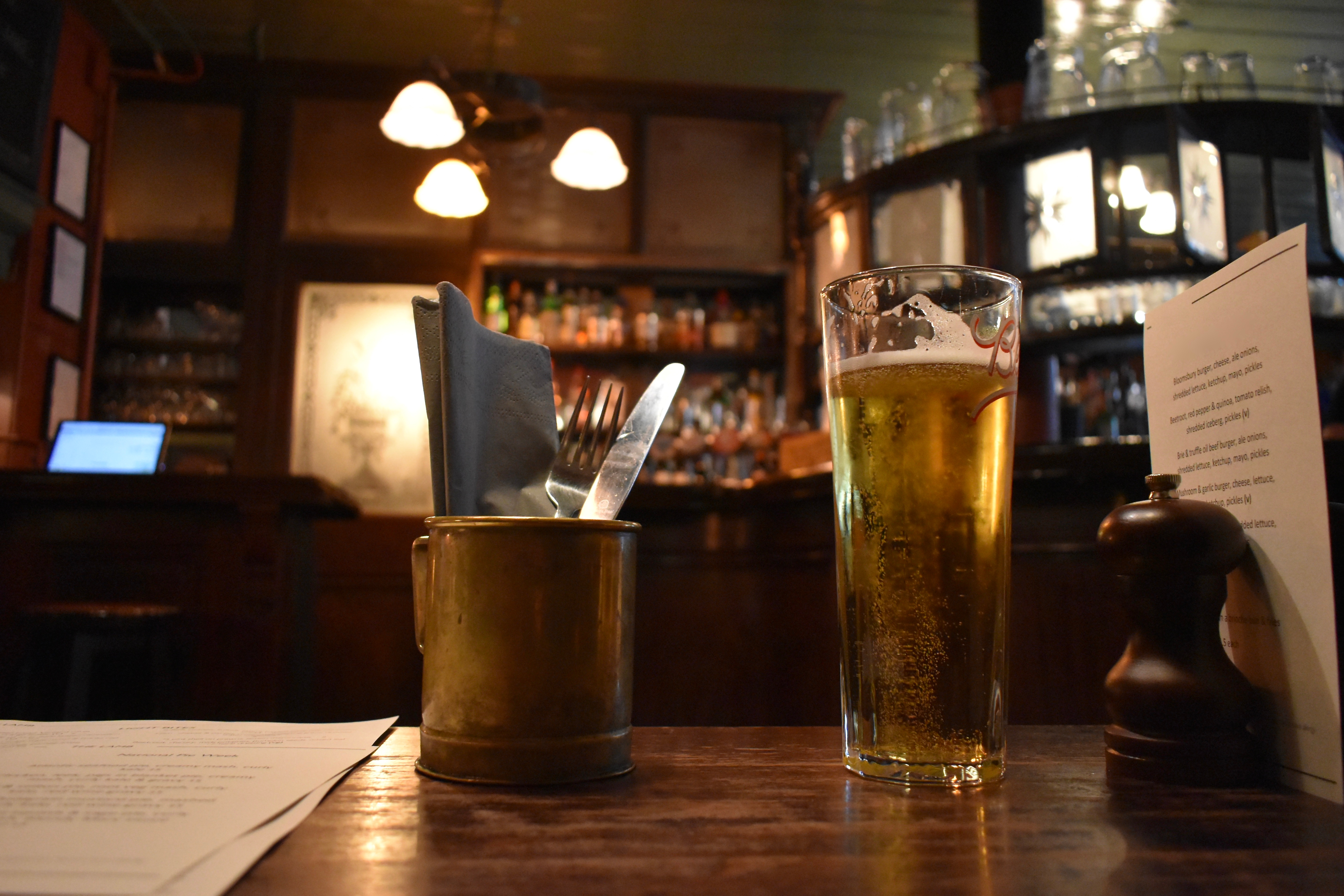 Cozy tavern table with a beverage and menu